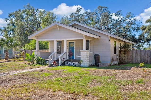 view of front of property with a porch and a front lawn