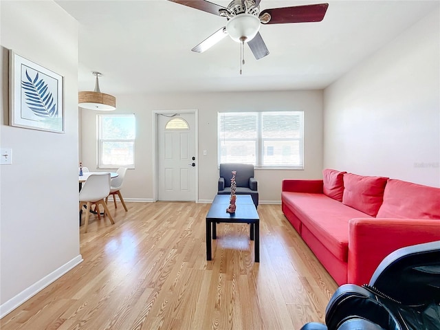 living room with hardwood / wood-style floors, ceiling fan, and a healthy amount of sunlight