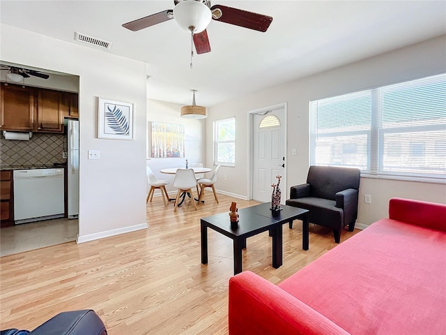 living room with light wood-type flooring and ceiling fan