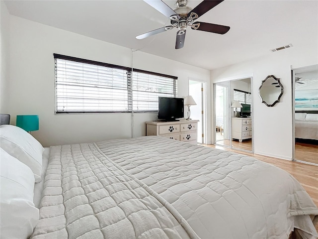 bedroom with ceiling fan, light wood-type flooring, and a closet