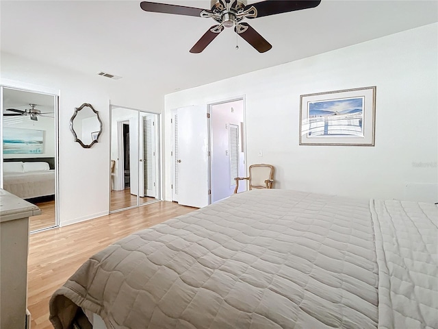 bedroom featuring ensuite bathroom, light hardwood / wood-style flooring, and ceiling fan