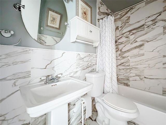 full bathroom featuring sink, shower / bath combination with curtain, tile walls, and toilet