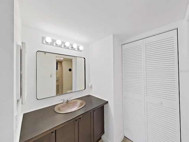 bathroom featuring a closet and vanity