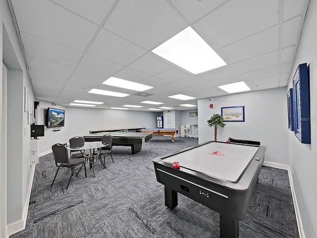 playroom featuring baseboards, a drop ceiling, and carpet flooring