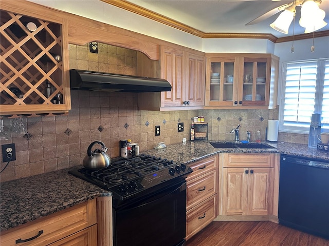 kitchen with ornamental molding, dark wood-type flooring, exhaust hood, black appliances, and dark stone countertops