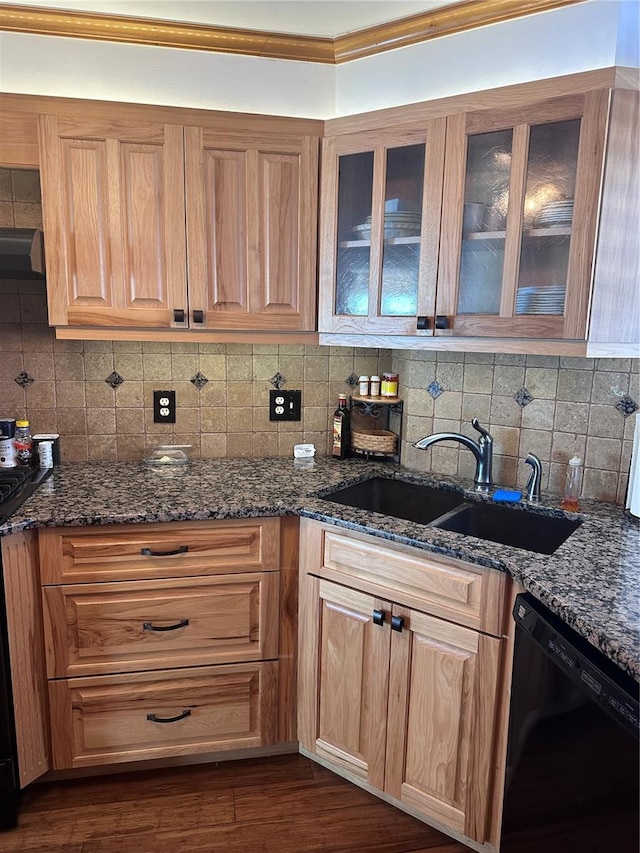 kitchen with dishwasher, sink, dark wood-type flooring, backsplash, and dark stone counters