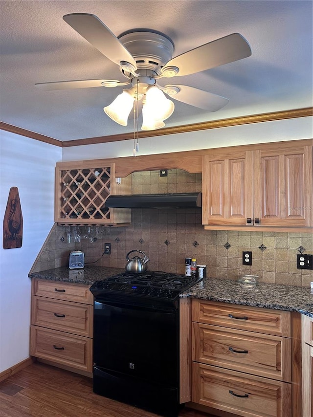 kitchen featuring dark wood-type flooring, electric range, decorative backsplash, dark stone countertops, and extractor fan