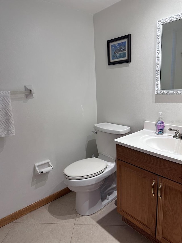 bathroom with tile patterned flooring, vanity, and toilet