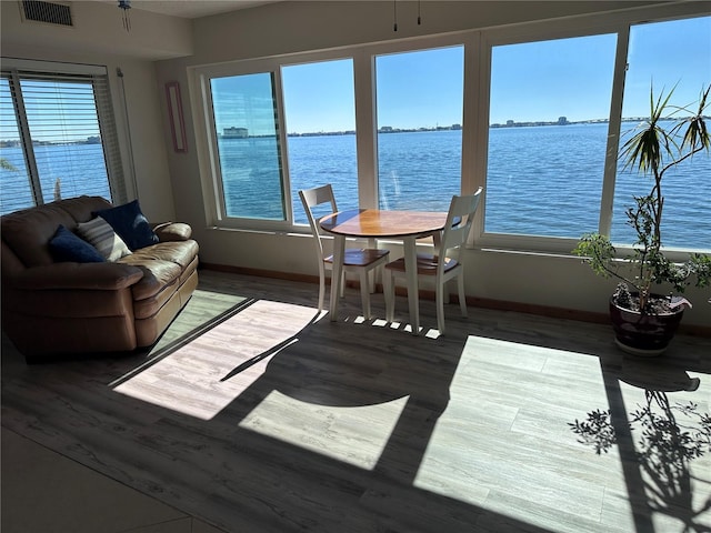 interior space with a wealth of natural light and a water view