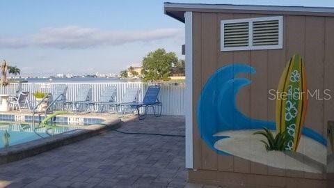 exterior space with a fenced in pool