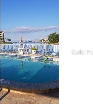 view of pool with a water view