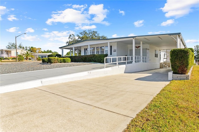 view of front of property featuring covered porch and a carport