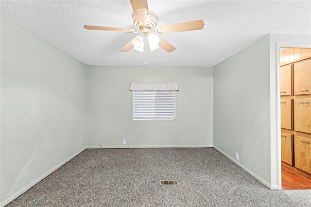 unfurnished bedroom with carpet flooring, ceiling fan, and a textured ceiling