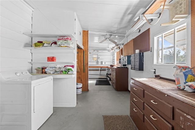 laundry area featuring washer / clothes dryer, ceiling fan, and wood walls