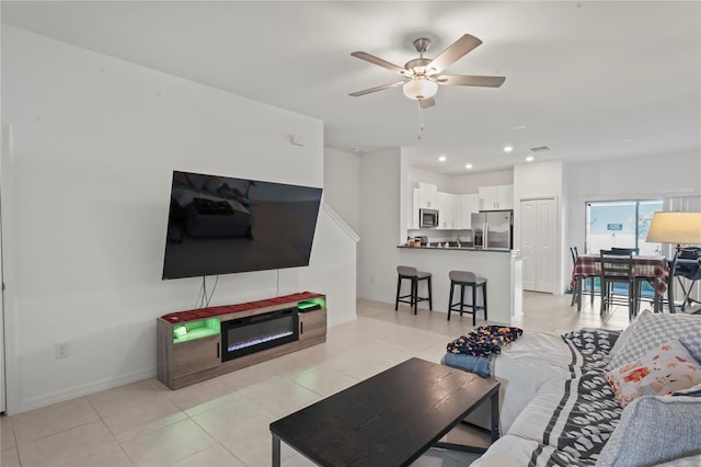 living room featuring ceiling fan and light tile patterned floors