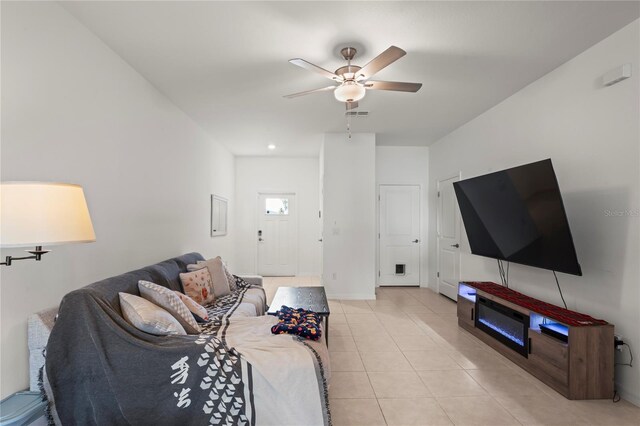 living room with light tile patterned floors and ceiling fan