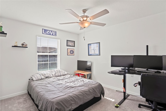 bedroom with ceiling fan and light carpet