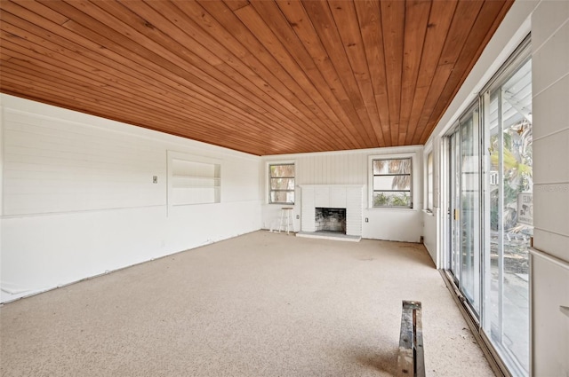 unfurnished living room featuring a fireplace and wooden ceiling