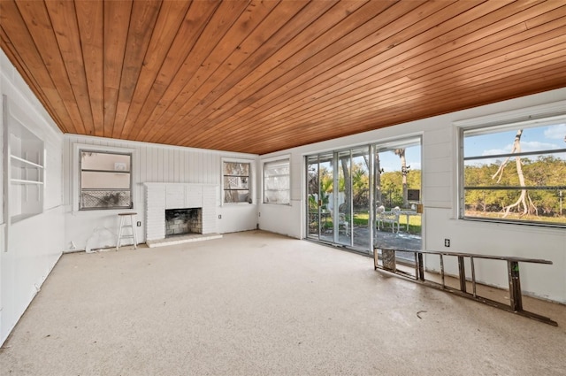 unfurnished living room featuring wood ceiling and a fireplace