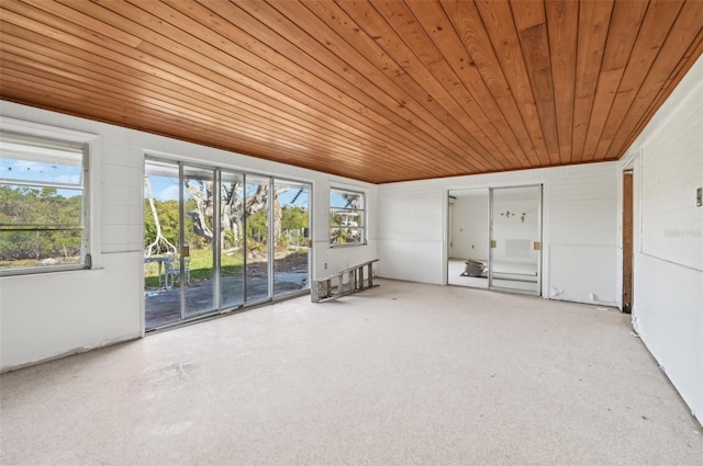 unfurnished sunroom with wood ceiling