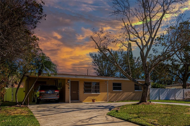 view of front of home with a yard and a carport