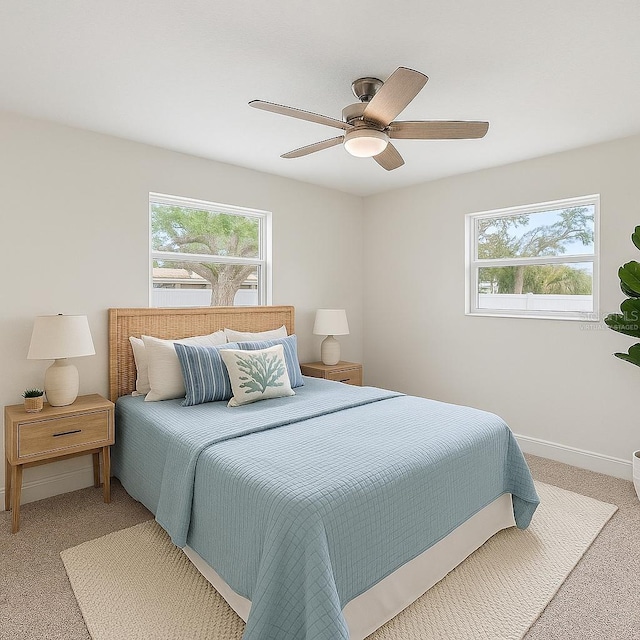 4145 Harrisburg St NE, Saint Petersburg, FL 33703 - bedroom with multiple windows, light carpet, baseboards, and ceiling fan