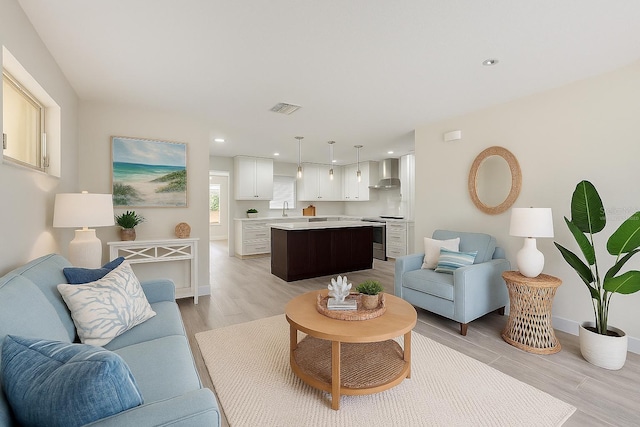 4145 Harrisburg St NE, Saint Petersburg, FL 33703 - living room with light wood-type flooring and recessed lighting