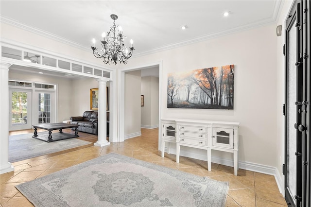 interior space featuring decorative columns, crown molding, and a notable chandelier