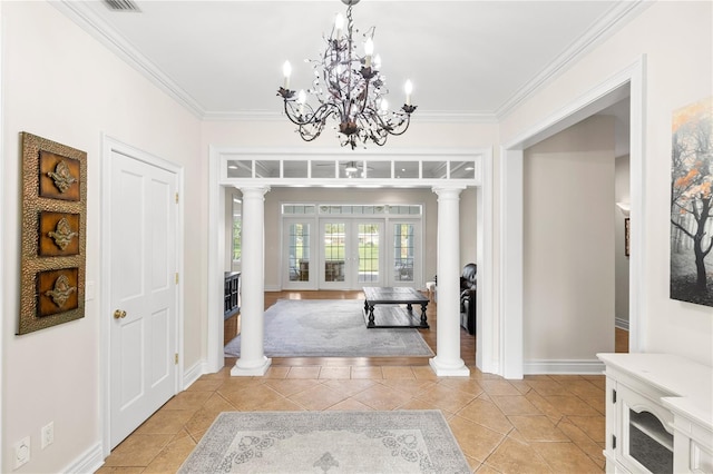 entryway with french doors, ornate columns, and ornamental molding