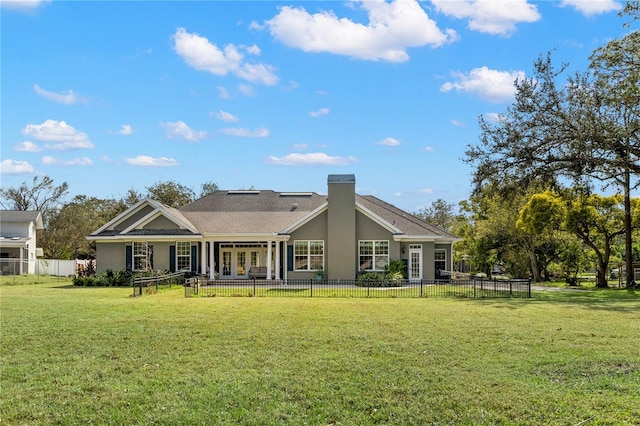 back of property featuring a lawn