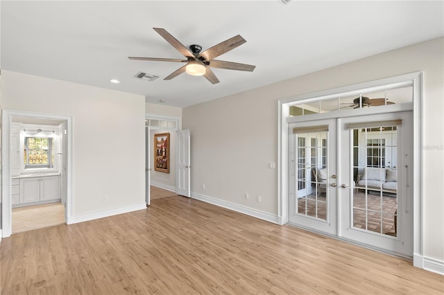 empty room featuring french doors, light hardwood / wood-style flooring, and ceiling fan