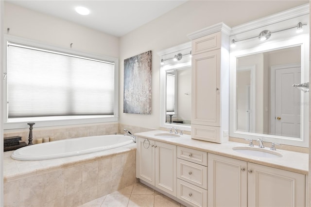 bathroom with vanity, tile patterned floors, and tiled tub