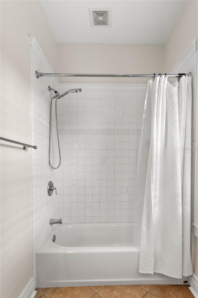 bathroom with tile patterned flooring and shower / bath combo