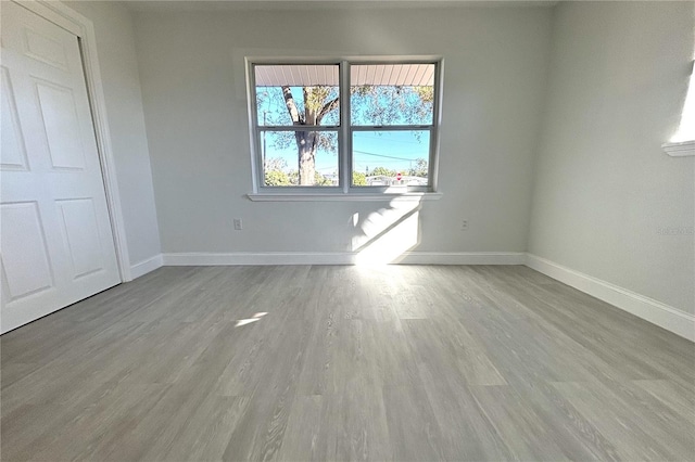 unfurnished room with light wood-type flooring