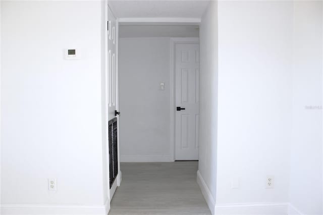 corridor featuring light hardwood / wood-style floors