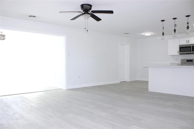 unfurnished living room with ceiling fan and light hardwood / wood-style floors