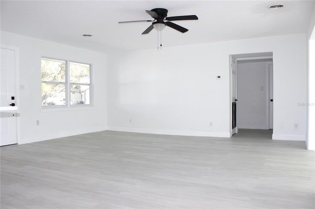 empty room with ceiling fan and light wood-type flooring