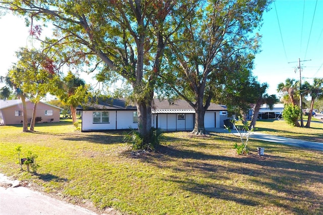 single story home featuring a front lawn and a garage