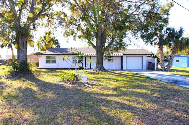 ranch-style home featuring a front yard and a garage