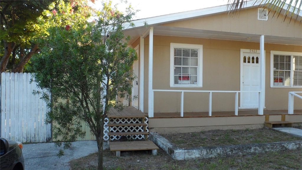 view of exterior entry with a porch