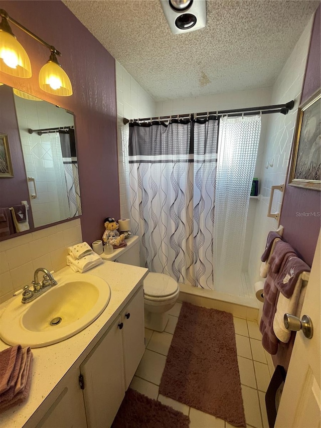 bathroom featuring tile patterned floors, vanity, a textured ceiling, and a shower with shower curtain