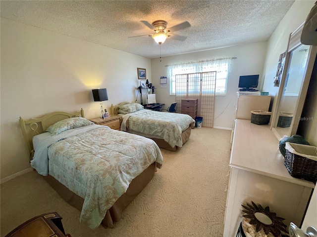 bedroom featuring ceiling fan, a textured ceiling, and carpet