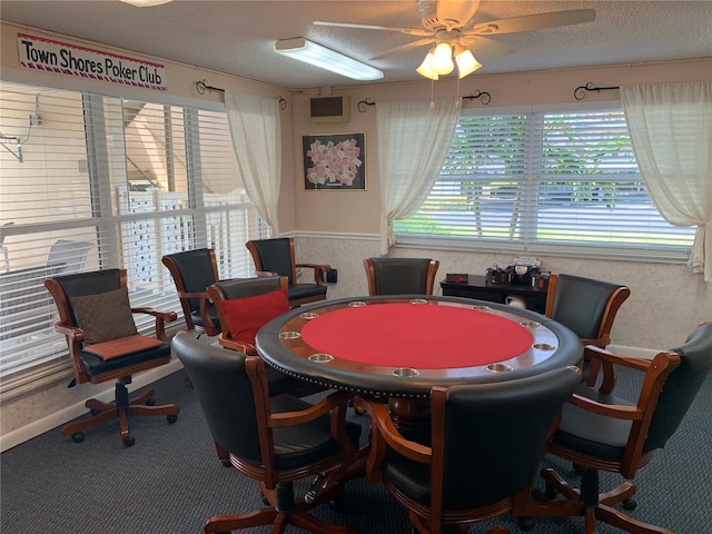 game room with ceiling fan, carpet flooring, and a textured ceiling