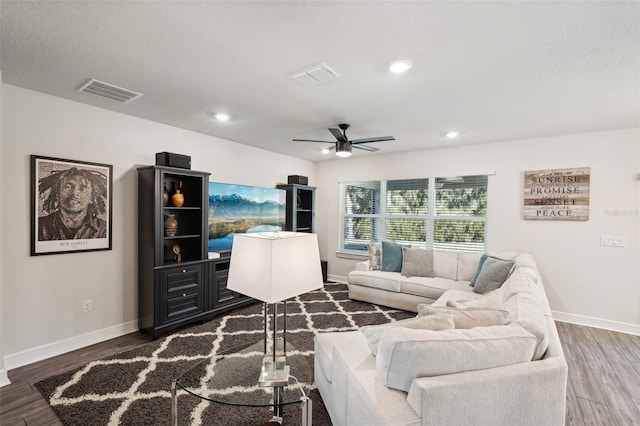 living room with hardwood / wood-style flooring and ceiling fan