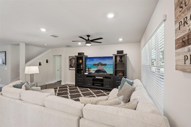 living room with dark hardwood / wood-style floors and ceiling fan