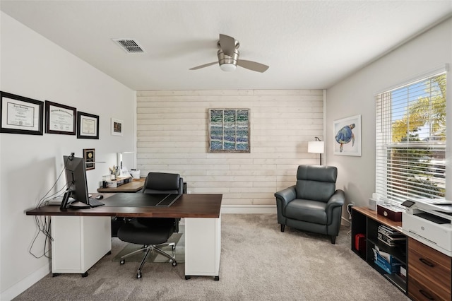 office space featuring ceiling fan and light carpet