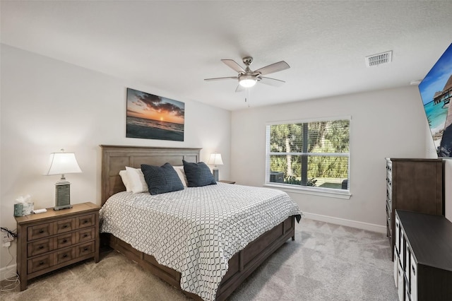 bedroom featuring ceiling fan and light carpet