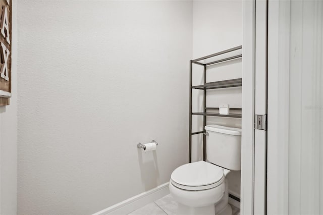 bathroom with tile patterned flooring, toilet, and baseboard heating