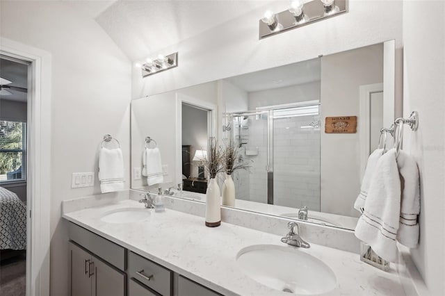 bathroom featuring vanity, vaulted ceiling, and walk in shower