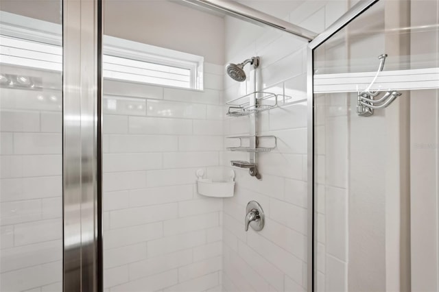 bathroom featuring a shower with shower door